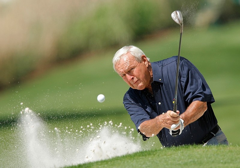 Former champion Arnold Palmer of the U.S hits from a sand trap during the annual Masters Par 3 golf tournament at the Augusta National Golf Club in Augusta (Reuters Photo)
