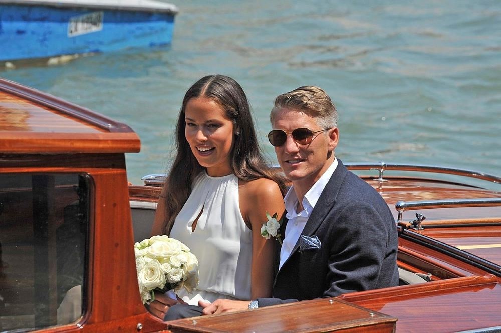 Serbian tennis player Ana Ivanovic and German soccer player Bastian Schweinsteiger sit on a boat after their wedding in Venice, Italy, 12 July 2016. (EPA Photo)