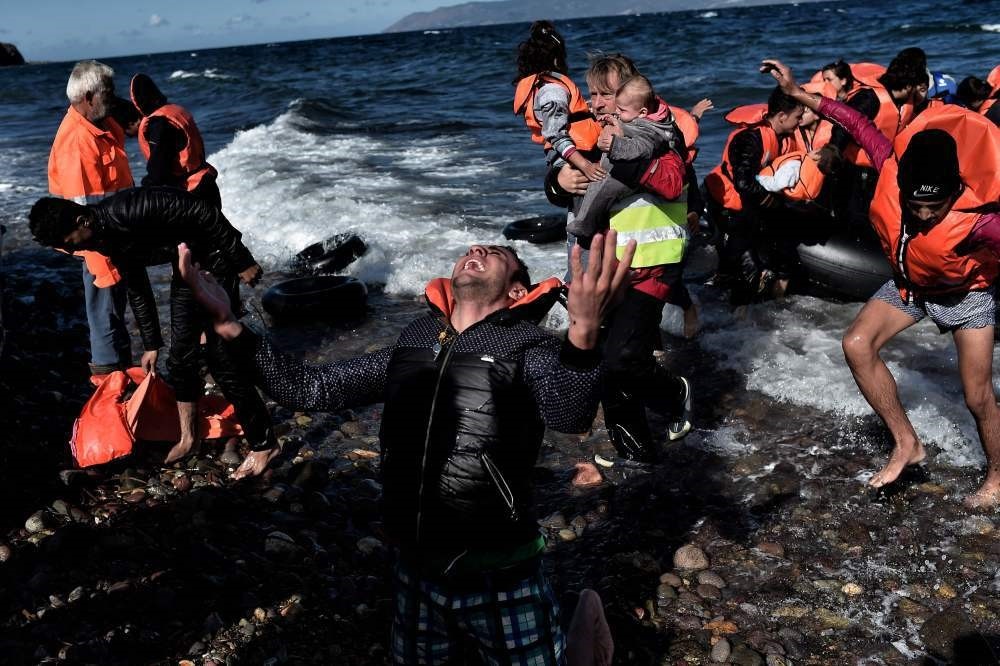A refugee reacting as he arrives, with other refugees and migrants, on the Greek island of Lesbos after crossing the Aegean Sea from Turkey. (AP Photo)