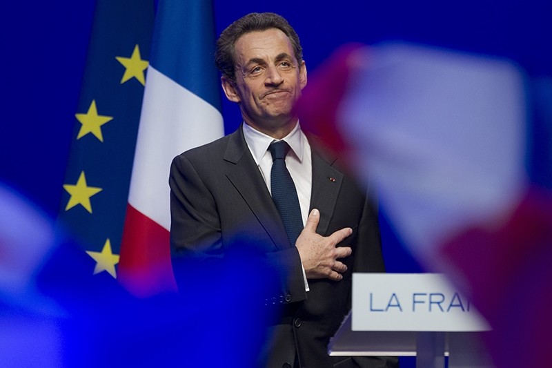 This Sunday May 6, 2012 file photo shows outgoing French President Nicolas Sarkozy acknowledging applause of his supporters at his Union for a Popular Movement (UMP) party headquarters. (AP Photo)