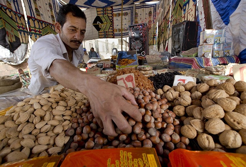 An Egyptian vendor arranges his goods at a market in the neighborhood of Sayeda Zeinab, in Cairo, Egypt, Tuesday, June 14, 2016. (AP Photo)