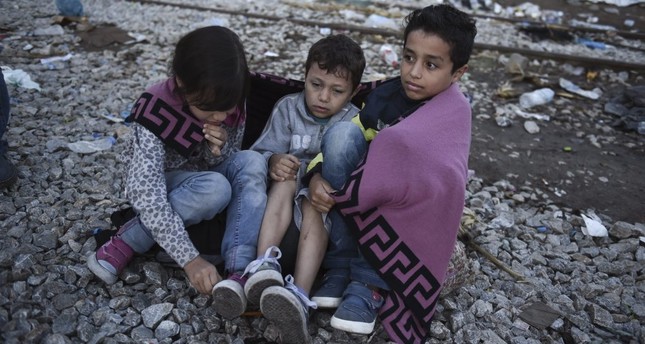 Syrian children as they wait to cross the border from the northern Greek village of Idomeni to southern Macedonia in September 2015.