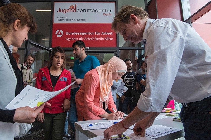 This file photo taken on June 16, 2016 shows participants registering for a professional training fair aimed at refugees, at an employment office in Berlin (AFP Photo)