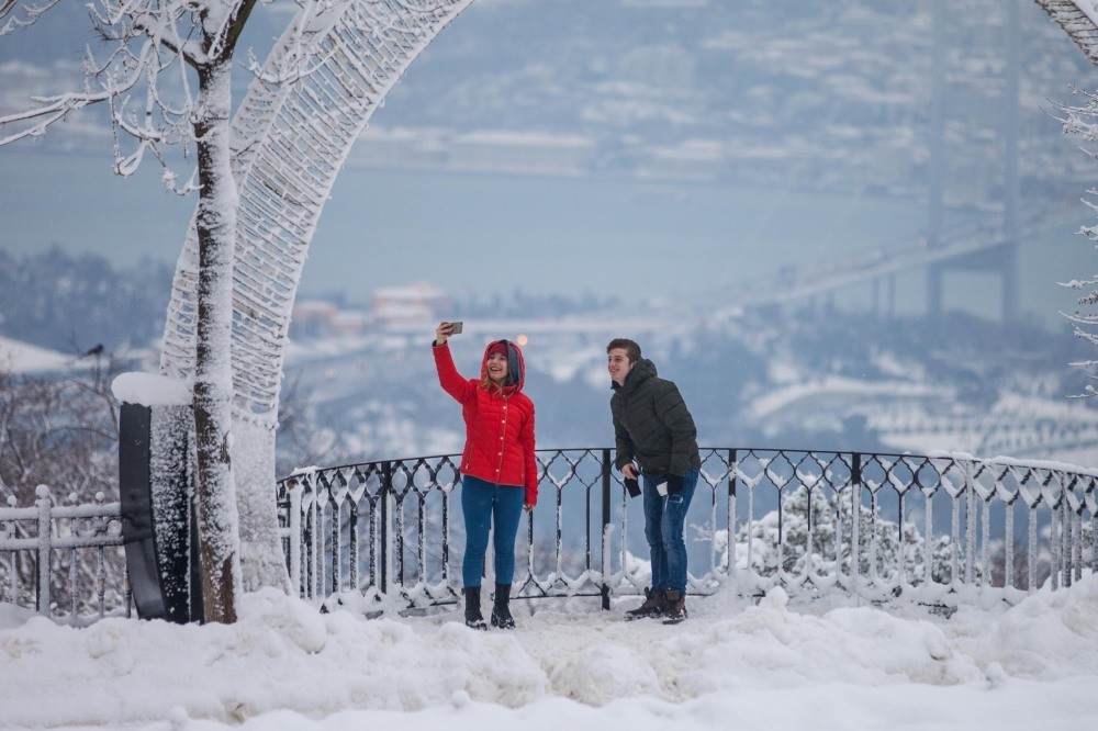 A couple taking a selfie with Bosporus view in Istanbul.