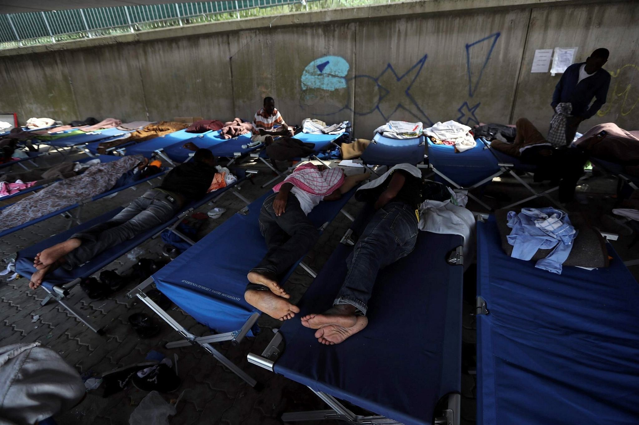 Migrants sleep on camp beds at a Red Cross center in the city of Ventimiglia on the French-Italian border on Sept. 14.