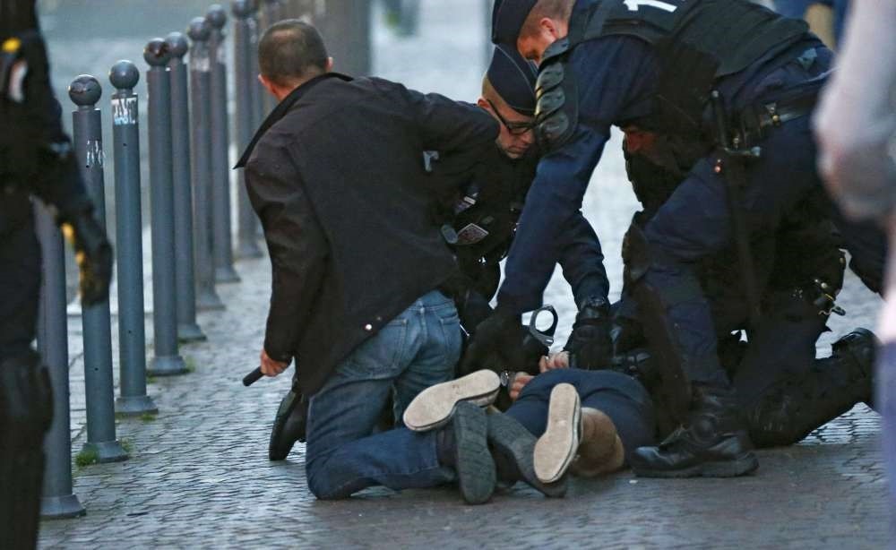 Police detain one of a small group of fans who were fighting in Lille.