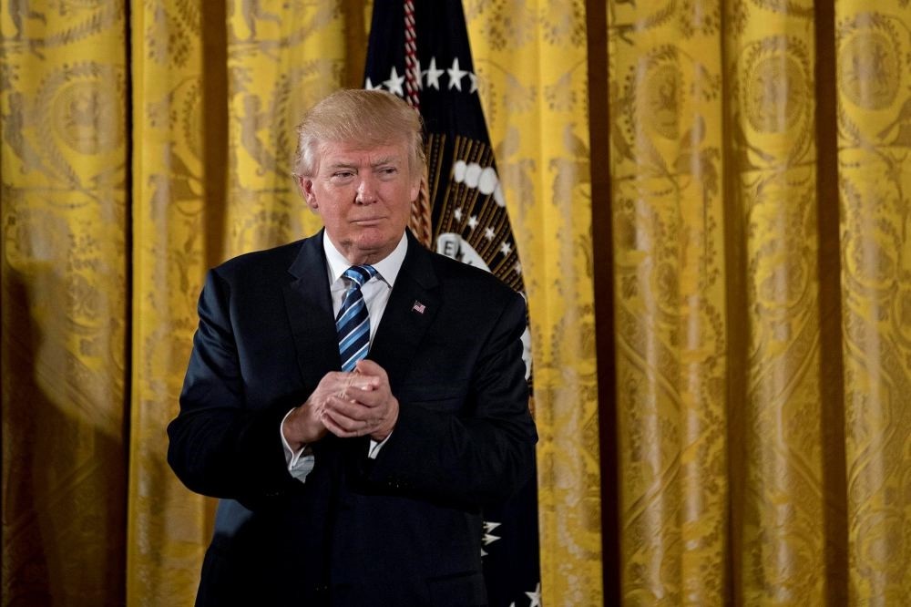 U.S. President Donald Trump listens during a swearing in ceremony of White House senior staff in the East Room of the White House in Washington, DC, U.S., on Jan. 22.
