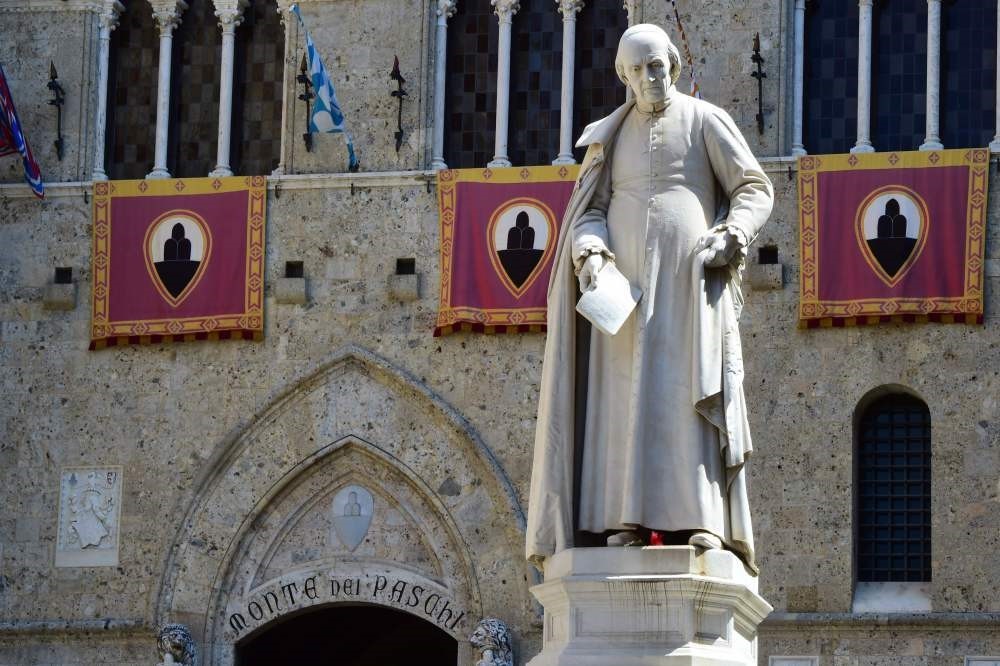 The statue of priest Sallustio Bandini at Piazza Salimbeni stands at the headquarters of the Monte dei Paschi di Siena bank in Tuscany.
