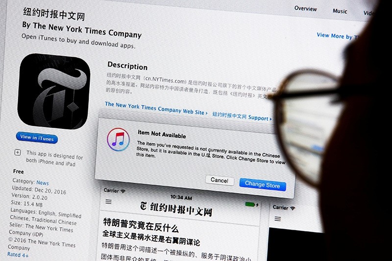 An illustration shows a person looking at a computer screen in Beijing showing anu00a0Appleu00a0iTunes store message saying that theu00a0Newu00a0Yorku00a0Timesu00a0app is not available in the Chinese store, China, Jan. 5, 2017. (Reuters Photo)