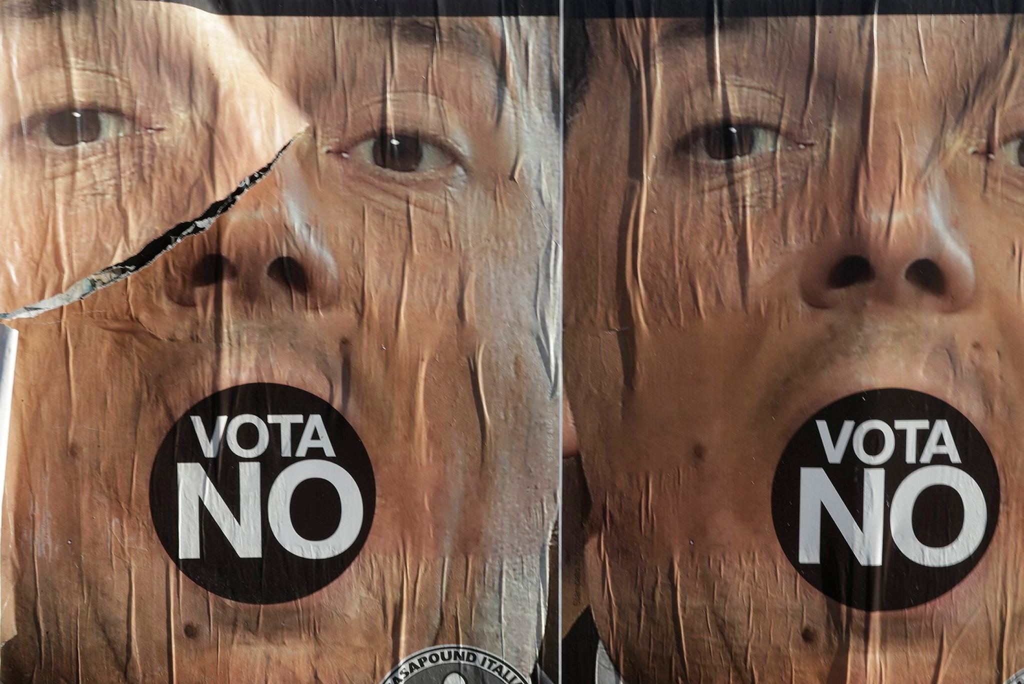 Anti-referendum posters showing Premier Matteo Renzi are seen in Rome a day after the referendum vote, Monday, Dec. 5, 2016. (AP Photo)