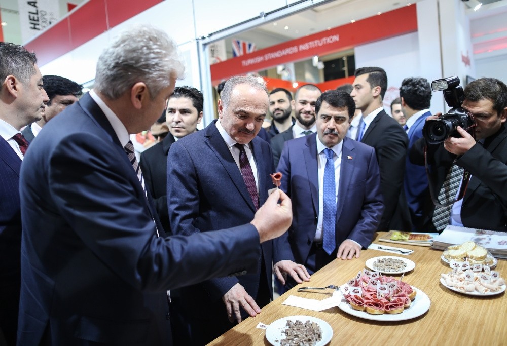 Minister of Science, Industry and Technology, Faruk u00d6zlu00fc, (second from the left), visits the stands in the exhibition area at the World Halal Summit in Istanbul.