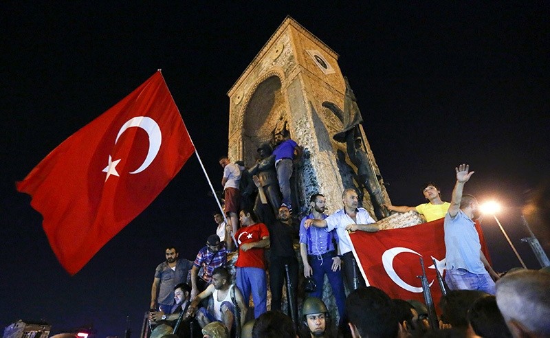 People wave flags as they demonstrate in the Taksim Square in Istanbul, Turkey, July 16, 2016. (Reuters Photo)