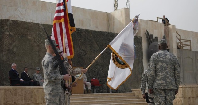 U.S. Secretary of Defense Leon Panetta, second from the left, and Ambassador to Iraq James Jeffrey, far left, at the U.S. Forces-Iraq colors casing ceremony, Baghdad, Iraq, Dec. 15, 2011.