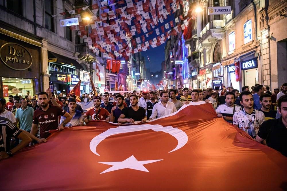 Turkish football supporters taking part in a rally against the failed coup attempt in Taksim Square, Istanbul on July 23. 