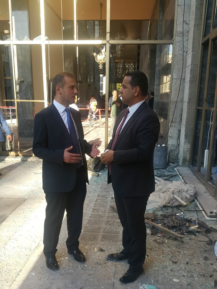 Kandemir (L) spoke to Ali u00dcnal from Daily Sabah in one of the demolished parts of the Parliament due to airstrike in the coup attempt on Friday.