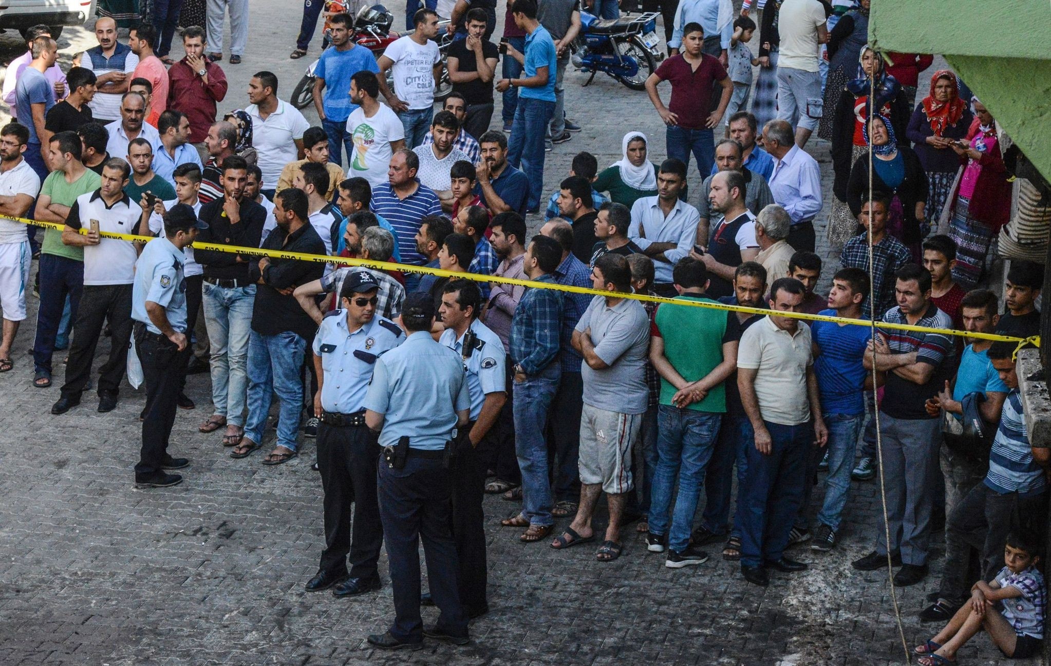People watch the explosion scene behind a police cordon in Gaziantep in southeastern Turkey near the Syrian border on August 21, 2016. (AFP Photo)