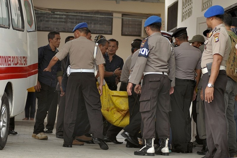Indonesian police transfer a body bag from an ambulance at a local hospital in Palu, Central Sulawesi province, on July 19, 2016. (AFP Photo)