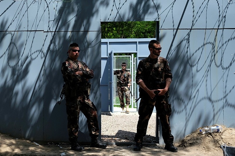Hungarian army soldiers stand guard at the Serbian-Hungarian border fence at a makeshift camp near the village of Horgos, Serbia, June 14, 2016. (Reuters Photo)
