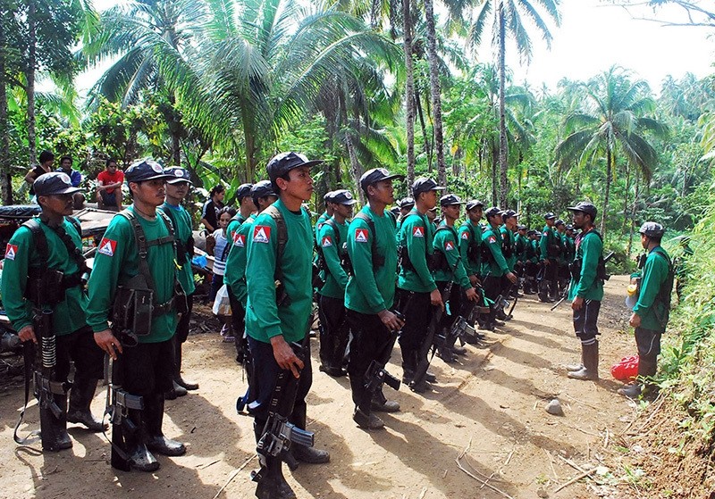 In this file photograph taken on December 26, 2009, New People's Army (NPA) rebels stand to attention during the 41st founding anniversary of the Communist Party of the Philippines in Surigao del Sur province of Mindanao Island. (AFP Photo)