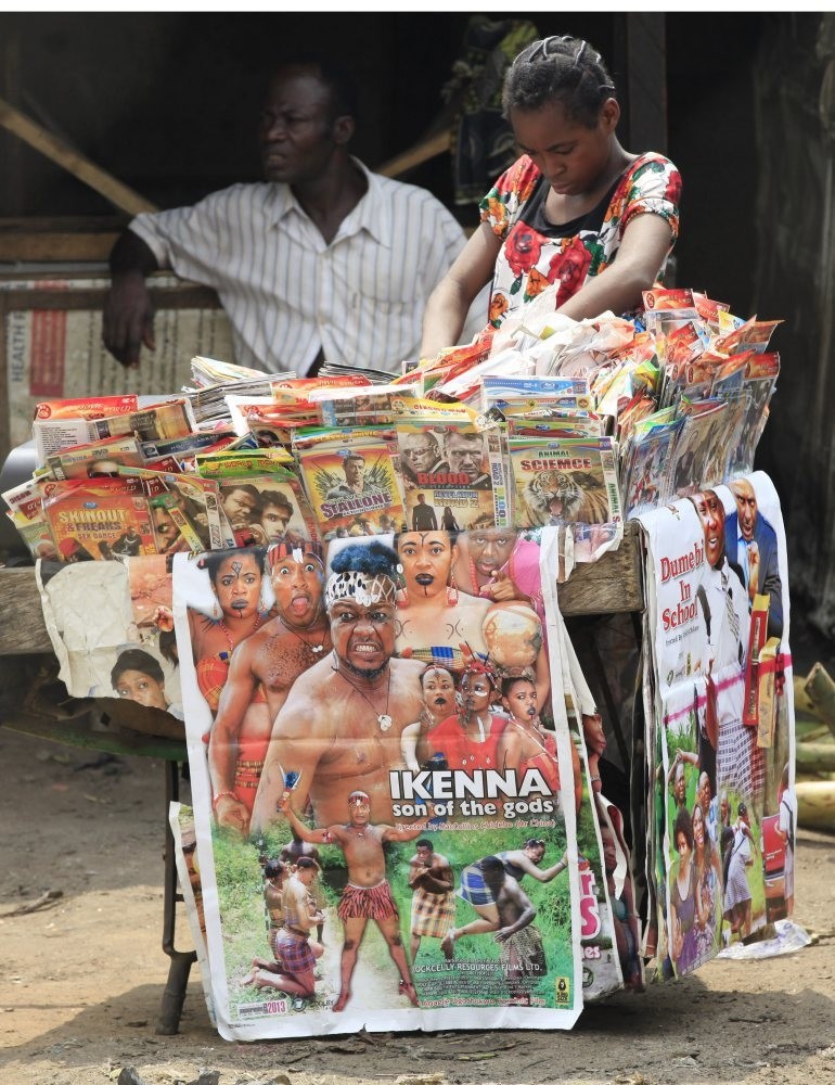 A woman shops for Nollywood DVDu2019s on a street in Lagos, Nigeria.