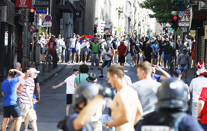 Russian fans (rear) face English supporters in a street at the Old Port of Marseille, France, 11 June 2016, before the UEFA EURO 2016 group B preliminary round match between England and Russia. (EPA Photo)