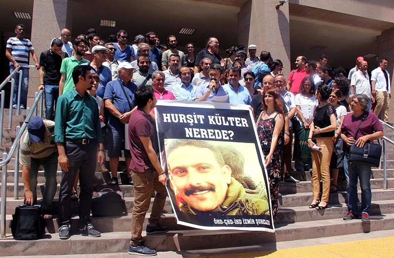 A group of people holding a poster with the photo of Huru015fit Ku00fclter, saying ,Where is Huru015fit Ku00fclter?, 