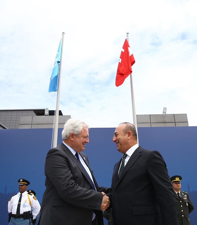 FM u00c7avuu015fou011flu and the United Nations' Under-Secretary-General for Humanitarian Affairs and Emergency Relief Coordinator Stephen O'Brien at the flag-hoisting ceremony on May 21, 2015. ( AA Photo)