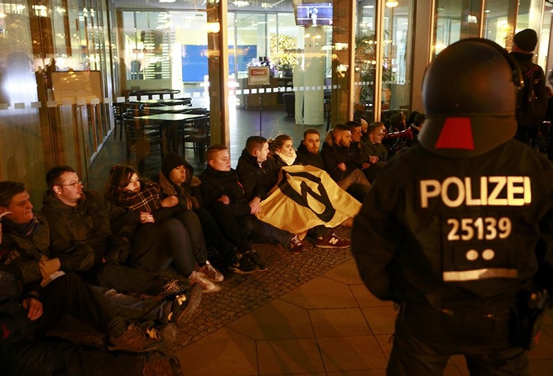 German police monitors supporters of the far right Identitarian movement (Identitaere Bewegung) who started a protest in front of the CDU headquarters in Berlin (Reuters Photo)