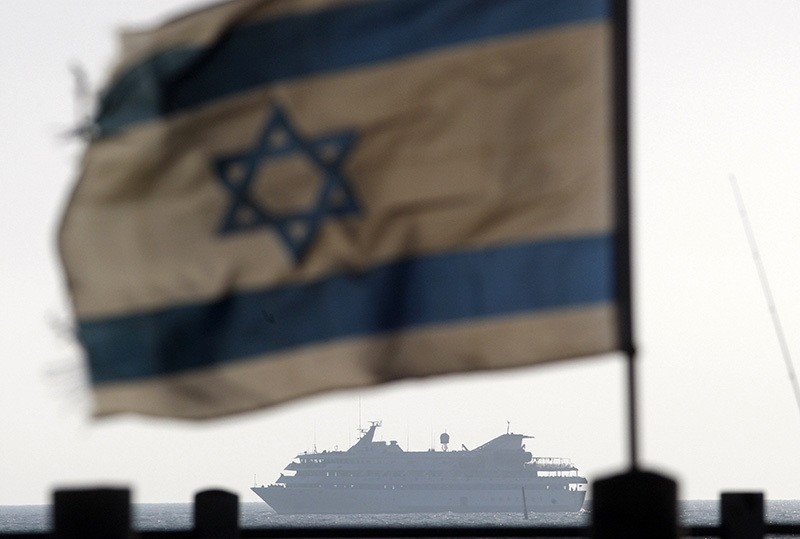 Israeli flag flutters in the wind as a naval vessel (not seen) escorts the Mavi Marmara, a Gaza-bound ship that was raided by Israeli marines, in this May 31, 2010 file picture. (Reuters)