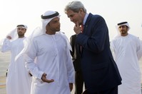 UAE Protocol Chief Shihab Al Faheem (centre L) seen in a traditional Emirati kandoorah, talks with U.S. Secretary of State John Kerry.  AFP PHOTO