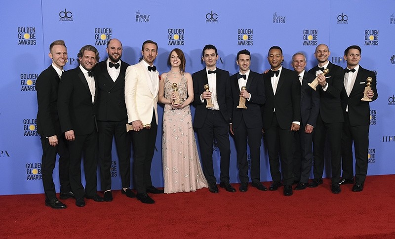 The cast and crew of ,La La Land, poses in the press room with the award for best motion picture - musical or comedy at the 74th annual Golden Globe Awards (AP Photo)