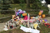 In this Sept. 27, 2016 photo, a memorial for Nisa Mickens and Kayla Cueva is located near the locations where their bodies were found in Brentwood, N.Y. (AP Photo)