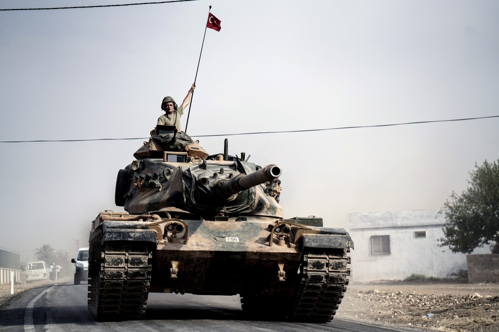 Turkish army tanks and armored personnel carriers moving toward Karkamu0131u015f in southeastern Gaziantep province on Turkey's border with Syria, Aug. 25.