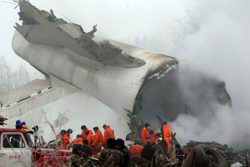 Crews at the scene of the plane crash inspect the debris of the fuselage.