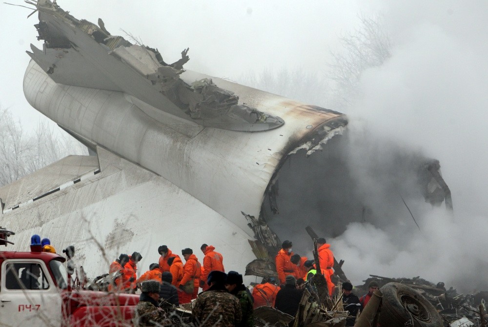 Crews at the scene of the plane crash inspect the debris of the fuselage.
