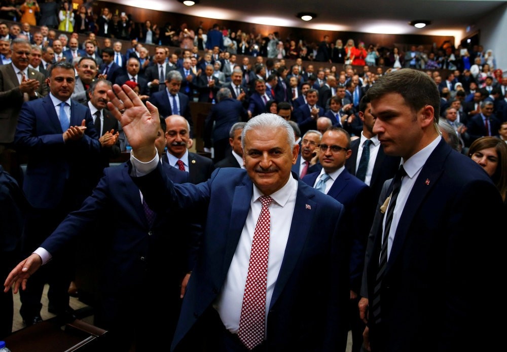 Turkey's new PM Binali Yu0131ldu0131ru0131m greeting AK Party deputies as he arrives for a meeting at Parliament in Ankara, May 24, 2016.