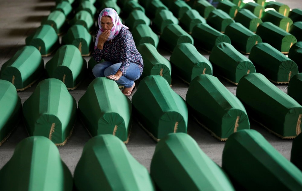 Muslim women crying amid coffins of their relatives, who are newly identified victims of the 1995 Srebrenica massacre, which are lined up for a joint burial in Potocari near Srebrenica, Bosnia-Herzegovina, July 9, 2016.