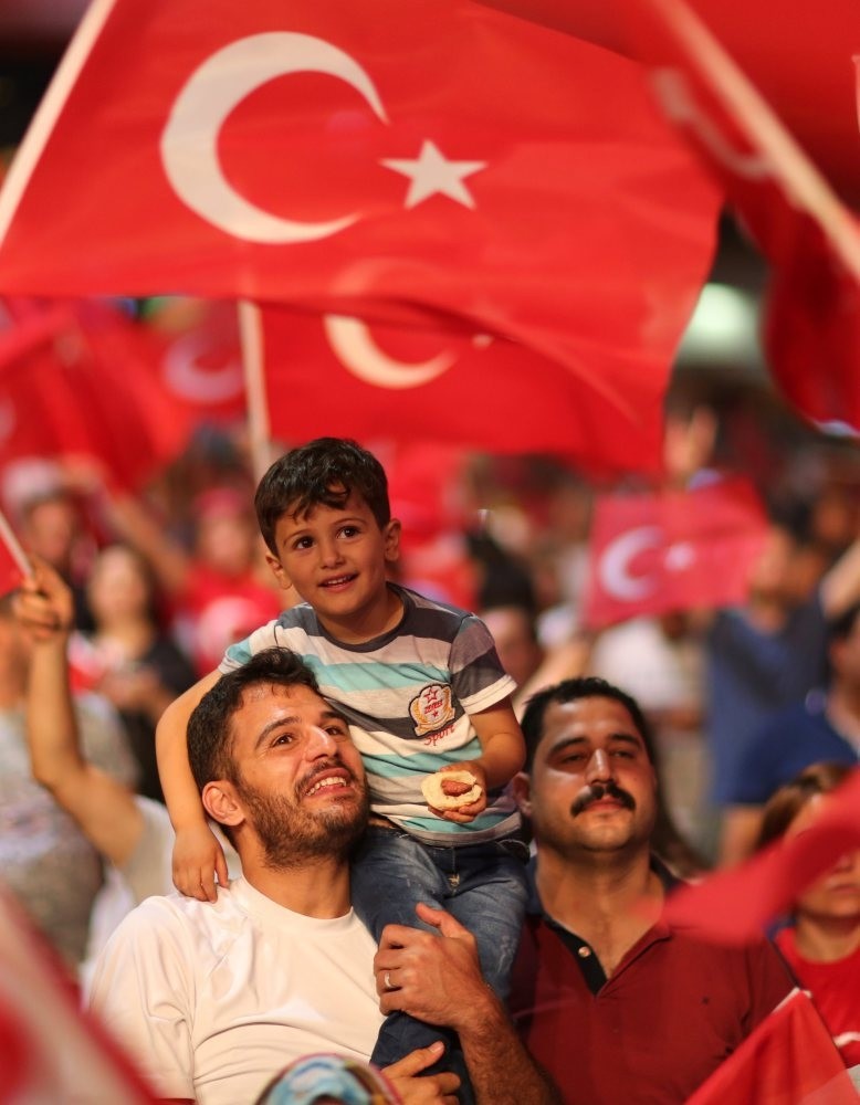 People shouting slogans against the failed coup attempt as they hold Turkish flags during a demonstration at Taksim Square in Istanbul, July 22.