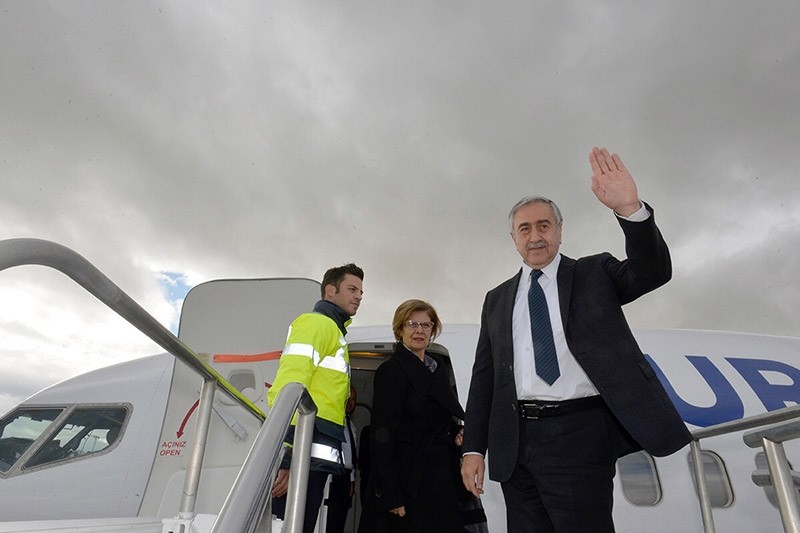 President of the Turkish Republic of Northern Cyprus (KKTC) Mustafa Aku0131ncu0131 (R) waves as he boards a plane at Ercan Airport in Turkish Republic of Northern Cyprus on Jan. 8, 2017. (AFP Photo)