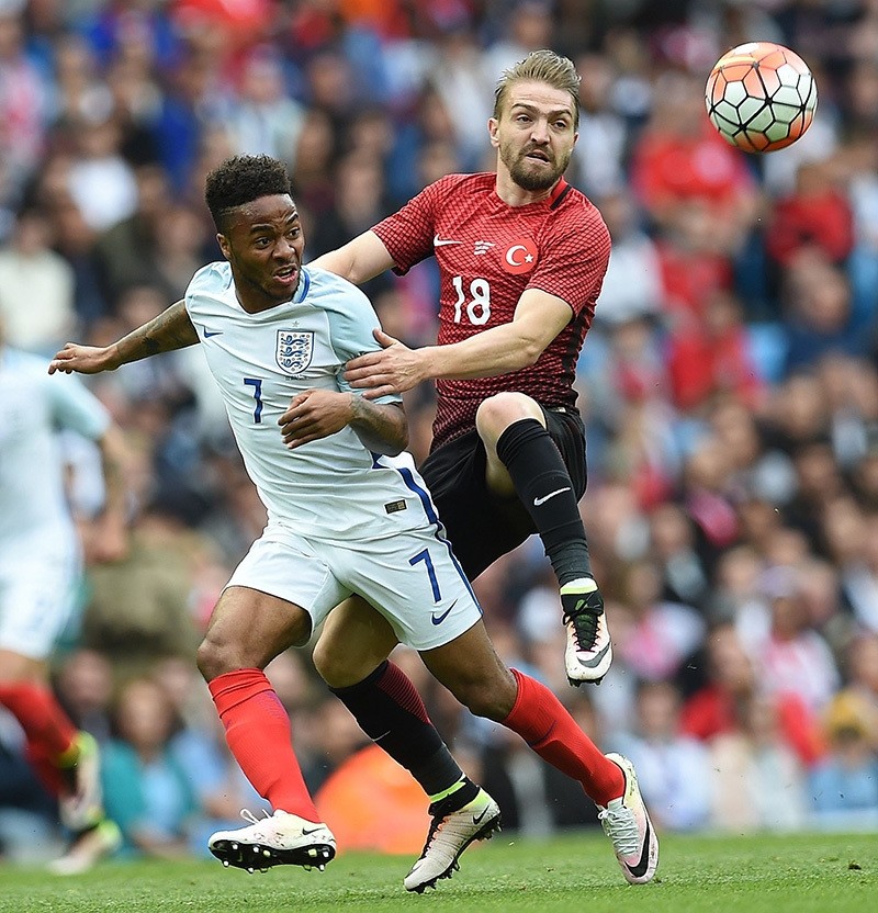 England's midfielder Raheem Sterling (L) vies with Turkey's midfielder Caner Erkin during the friendly football match between England and Turkey at the Etihad Stadium in Manchester, north west England, on May 22, 2016. (AFP Photo)