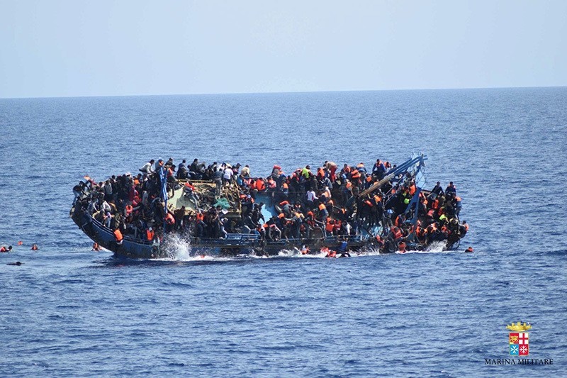 Migrants are seen on a capsizing boat before a rescue operation by Italian navy ships ,Bettica, and ,Bergamini, (unseen) off the coast of Libya in this handout picture released by the Italian Marina Militare on May 25, 2016. (Reuters Photo)
