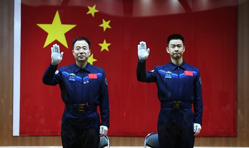 Chinese astronauts Jin Haipeng (L) and Chen Dong (R) wave during a 'meet the media' session at the Jiuquan Satellite Launch Center in Jiuquan, Gansu province, China, 16 October 2016 (EPA Photo)