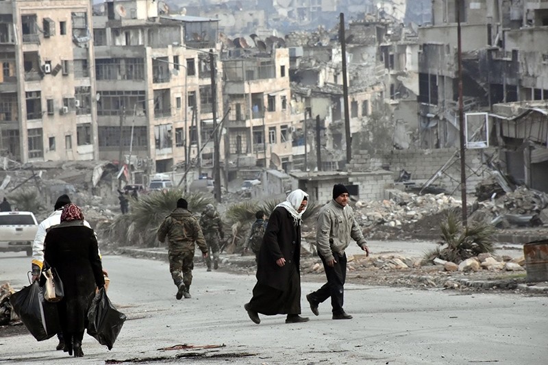 A handout photo shows people walking in Zabadia and Salah Eddin district in Aleppo, Syria, 23 December 2016 (EPA Photo)