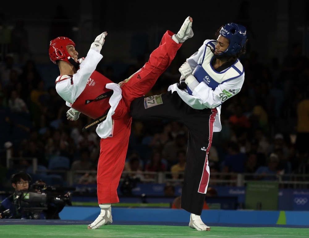 Ghofran Ahmed of Egypt (R) and Ahmad Abu Ghosh of Palestinian origin Jordanian compete in a men's Taekwondo 68-kg event at the 2016 Summer Olympics in Rio de Janeiro, Aug. 18, 2016.