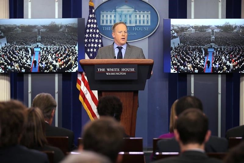 Press Secretary Sean Spicer delivers a statement while television screens show pictures of U.S. President Donald Trump's inauguration at the press briefing room of the White House (Reuters Photo)