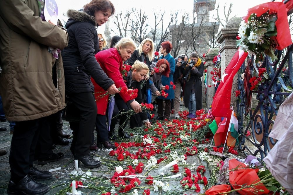 People leave flowers in the site of the blast at Sultanahmet Square.
