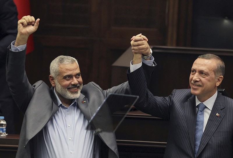  In this Tuesday, Jan. 3, 2012 file photo, Gaza's Hamas Prime Minister Ismail Haniyeh, left, and then Turkish Prime Minister Recep Tayyip Erdogan salute lawmakers in AK Party group meeting (AP Photo)