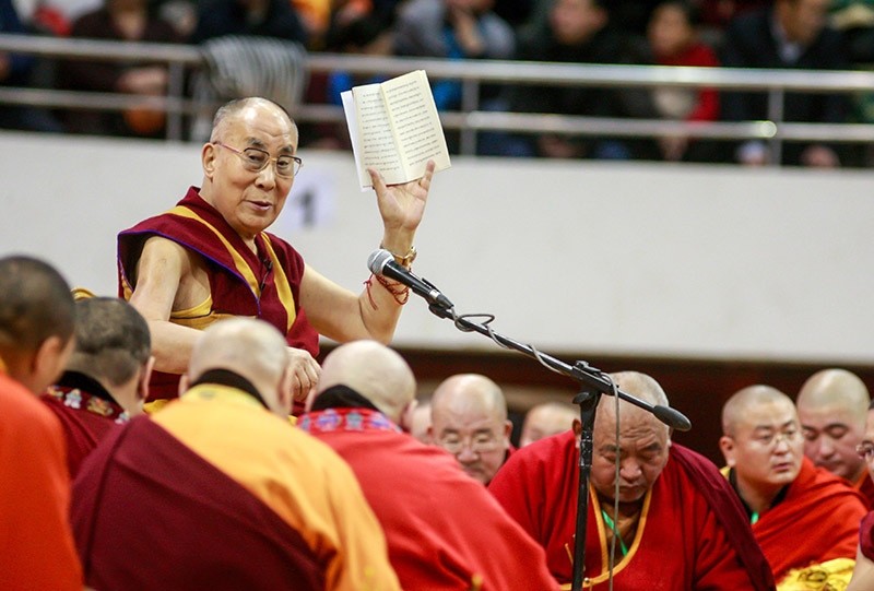 The Dalai Lama waves to worshippers during ceremonies at the Buyant Ukhaa sports stadium in Ulaanbaatar, the capital city of Mongolia, on Nov. 20, 2016. (AFP Photo)