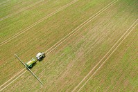 A farmer on a tractor sprays selective herbicides to control weeds on a field of sugar beets in Mustedt, Germany, May 30, 2016. (EPA Photo)