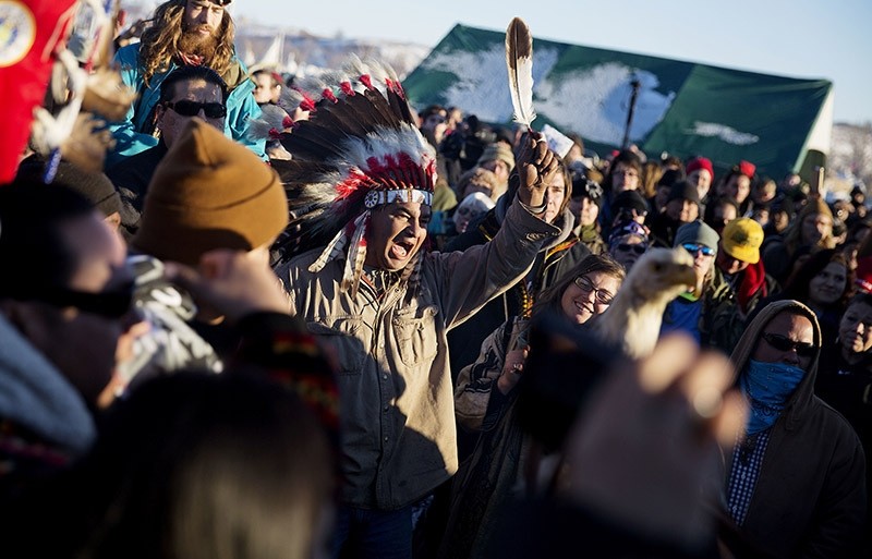 A crowd gathers in celebration at the Oceti Sakowin camp after it was announced that the U.S. Army Corps of Engineers won't grant easement for the Dakota Access oil pipeline in Cannon Ball, N.D., Sunday, Dec. 4, 2016. (AP photo)